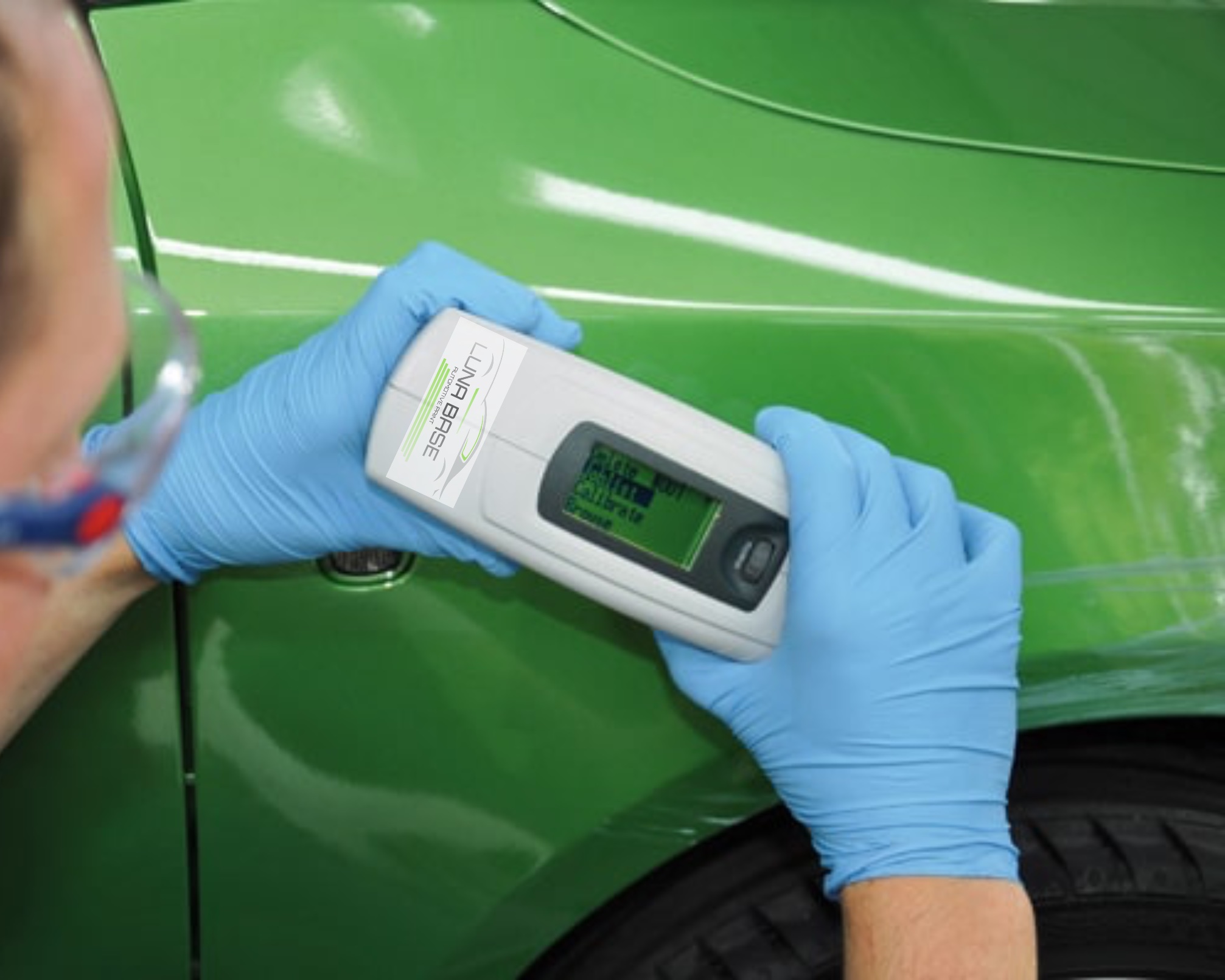 Technician using a spectrometer on a car panel